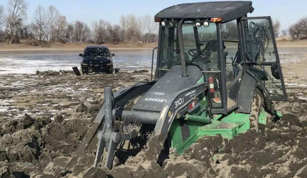 Chevy Silverado and backhoe stuck in frozen lake 01