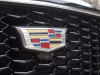 cadillac-logo-on-grille-of-2019-cadillac-xt4-sport-exterior-in-stellar-black-metallic-at-cadillac-event-001