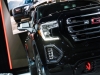 2019-gmc-sierra-at4-1500-exterior-live-at-2018-new-york-auto-show-022-front-end-spotlight-with-headlight-and-grille-and-gmc-logo