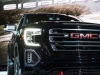 2019-gmc-sierra-at4-1500-exterior-live-at-2018-new-york-auto-show-021-front-end-spotlight-with-headlight-and-grille-and-gmc-logo