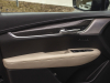 2020-cadillac-xt5-sport-interior-021-front-passenger-door-panel-bose-performance-series-speaker-grille-treatment-carbon-fiber-decor-stitcing