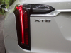 2020-cadillac-xt6-sport-exterior-xt6-drive-forest-012-tail-light-with-xt6-badge-logo