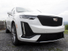 2020-cadillac-xt6-sport-exterior-xt6-drive-winery-008-front-three-quarters-headlight-and-grille-focus