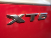 xt6-badge-logo-on-2020-cadillac-xt6-sport-in-red-horizon-tintcoat-2020-xt6-first-drive-lobby-001