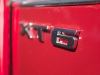 xt6-badge-logo-on-2020-cadillac-xt6-sport-in-red-horizon-tintcoat-2020-xt6-first-drive-lobby-002