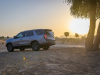 2021-chevrolet-tahoe-z71-middle-east-exterior-015-rear-three-quarters-dirt-road