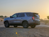 2021-chevrolet-tahoe-z71-middle-east-exterior-016-rear-three-quarters-dirt-road