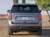 2021-chevrolet-tahoe-z71-middle-east-exterior-019-rear-end-dirt-road