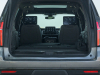 2021-chevrolet-tahoe-z71-middle-east-exterior-022-rear-end-dirt-road-liftgate-open-third-row-folded
