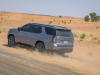 2021-chevrolet-tahoe-z71-middle-east-exterior-032-rear-three-quarters-dirt