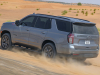 2021-chevrolet-tahoe-z71-middle-east-exterior-033-rear-three-quarters-dirt