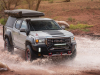 2021-gmc-canyon-at4-ovrlandx-concept-manufacturer-photos-exterior-009-front-three-quarters-driving-through-puddle