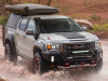 2021-gmc-canyon-at4-ovrlandx-concept-manufacturer-photos-exterior-010-front-three-quarters-driving-through-puddle