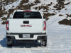 2021-gmc-canyon-at4-summit-white-crew-cab-short-bed-gma-garage-exterior-008-rear-end-snow