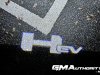 2022-gmc-hummer-ev-pickup-edition-1-gma-garage-exterior-at-night-001-hummer-ev-logo-projected-on-ground