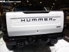 2022-gmc-hummer-ev-pickup-edition-1-sema-2021-live-photos-interstellar-white-exterior-005-rear-tail-lights-hummer-ev-and-gmc-logos-on-tailgate-multipro-tailgate-backup-camera