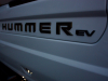 2022-gmc-hummer-ev-pickup-edition-1-with-official-accessories-2021-sema-live-photos-exterior-007-multipro-tailgate-with-hummer-ev-scrip