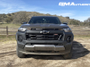 2023-chevrolet-colorado-trail-boss-harvest-bronze-metallic-gxn-first-drive-exterior-011-front-front-fascia-headlights-black-chevy-bowtie-logo-badge-on-grille