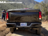 2023-chevrolet-colorado-trail-boss-harvest-bronze-metallic-gxn-offroad-first-drive-exterior-004-rear-chevrolet-script-debossed-in-tailgate-taillights-reverse-lights-on