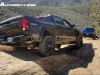 2023-chevrolet-colorado-trail-boss-harvest-bronze-metallic-gxn-offroad-first-drive-exterior-005-side-rear-three-quarters-taillights-reverse-lights-on-cornerstep-bumper-spare-tire-exhaust