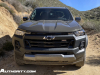 2023-chevrolet-colorado-trail-boss-harvest-bronze-metallic-gxn-offroad-first-drive-exterior-008-front-incandescent-headlights-black-chevy-logo-grille