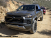 2023-chevrolet-colorado-trail-boss-harvest-bronze-metallic-gxn-offroad-first-drive-exterior-010-front-three-quarters-incandescent-headlights-black-chevy-logo-grille