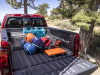2023-chevrolet-colorado-trail-boss-press-photos-exterior-027-bed-camping-and-overlanding-gear-chevy-logo-spray-in-bedliner