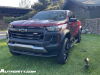 2023-chevrolet-colorado-trail-boss-radiant-red-tintcoat-gnt-first-drive-exterior-002-front-three-quarters-accessory-wheels-steps