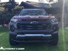 2023-chevrolet-colorado-trail-boss-radiant-red-tintcoat-gnt-first-drive-exterior-003-front-front-fascia-incandescent-headlights-grille