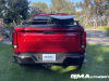2023-chevrolet-colorado-trail-boss-radiant-red-tintcoat-gnt-first-drive-exterior-008-rear-tail-lights-stowflex-tailgate-tonneau-cover-removable-rail-kit-by-thule-surf-board