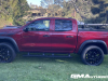 2023-chevrolet-colorado-trail-boss-radiant-red-tintcoat-gnt-first-drive-exterior-010-side-tonneau-cover-removable-rail-kit-by-thule-surf-board
