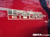 2023-chevrolet-colorado-trail-boss-radiant-red-tintcoat-gnt-first-drive-exterior-015-trail-boss-logo-on-bedside