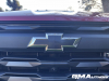 2023-chevrolet-colorado-trail-boss-radiant-red-tintcoat-gnt-first-drive-exterior-019-black-chevy-bowtie-on-grille