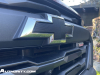 2023-chevrolet-colorado-trail-boss-radiant-red-tintcoat-gnt-first-drive-exterior-020-black-chevy-bowtie-on-grille