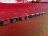2023-chevrolet-colorado-trail-boss-radiant-red-tintcoat-gnt-first-drive-exterior-026-black-colorado-logo-badge-on-door