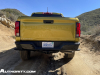 2023-chevrolet-colorado-z71-nitro-yellow-metallic-gcp-offroad-first-drive-exterior-005-rear-chevrolet-script-debossed-in-tailgate-tail-lights-cornerstep-bumper