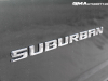 2023-chevrolet-suburban-gma-garage-high-country-lm2-duramax-diesel-silver-sage-metallic-g6n-exterior-120-suburban-logo-script-on-door