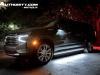 2023-chevrolet-suburban-high-country-gma-garage-night-time-lights-exterior-002-side-front-three-quarters