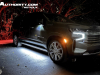 2023-chevrolet-suburban-high-country-gma-garage-night-time-lights-exterior-003-side-front-three-quarters