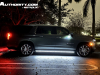 2023-chevrolet-suburban-high-country-gma-garage-night-time-lights-exterior-004-side