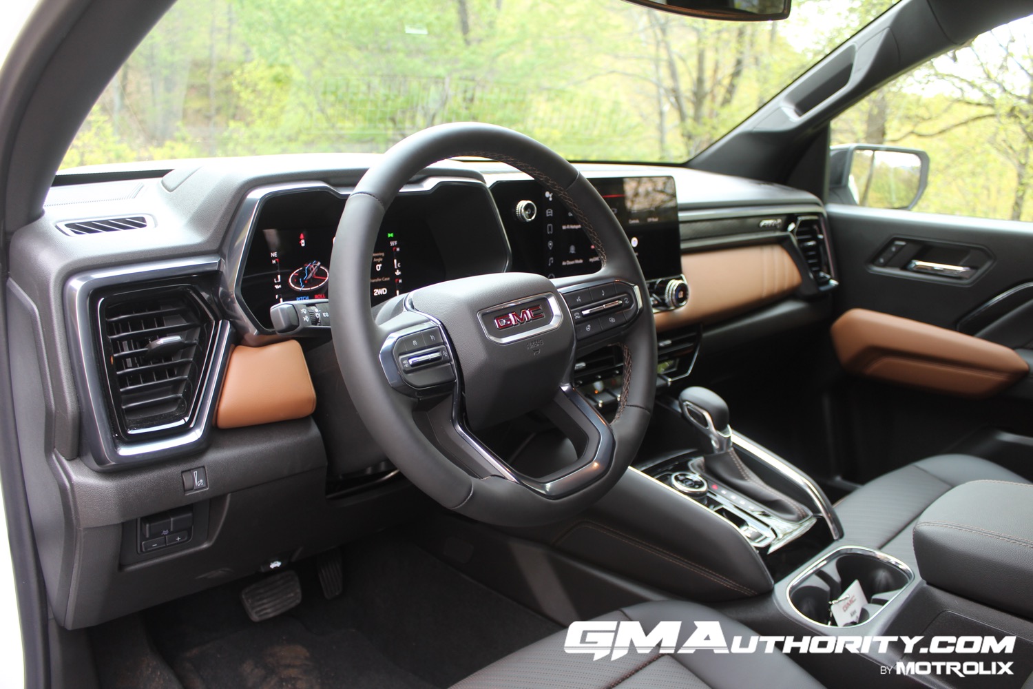 2023-gmc-canyon-at4-jet-black-with-timber-hx6-first-drive-interior-006-cockpit-dash-steering-wheel-center-stack-center-console