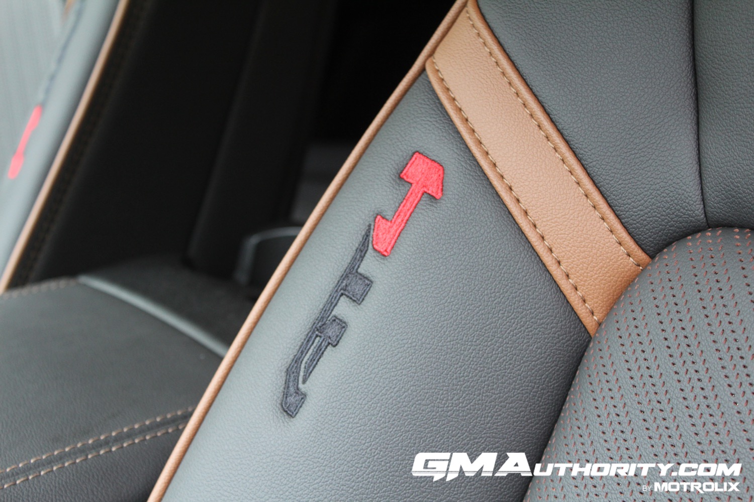 2023-gmc-canyon-at4-jet-black-with-timber-hx6-first-drive-interior-010-embroidered-at4-logo-on-front-seat-bolster