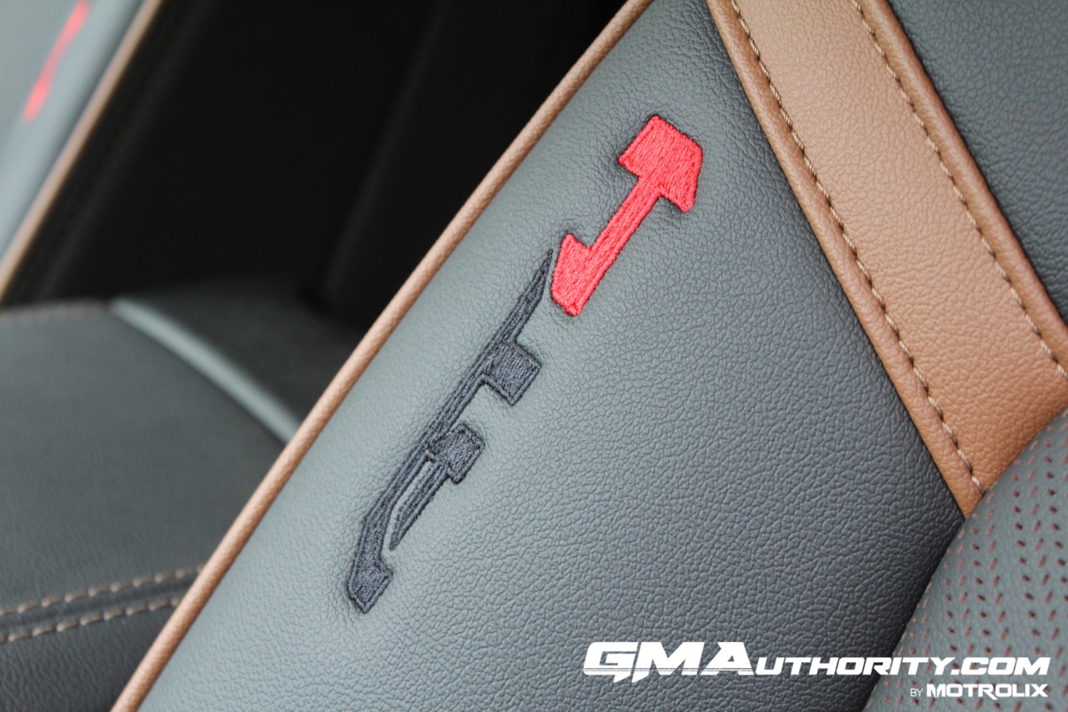 2023-gmc-canyon-at4-jet-black-with-timber-hx6-first-drive-interior-011-embroidered-at4-logo-on-front-seat-bolster