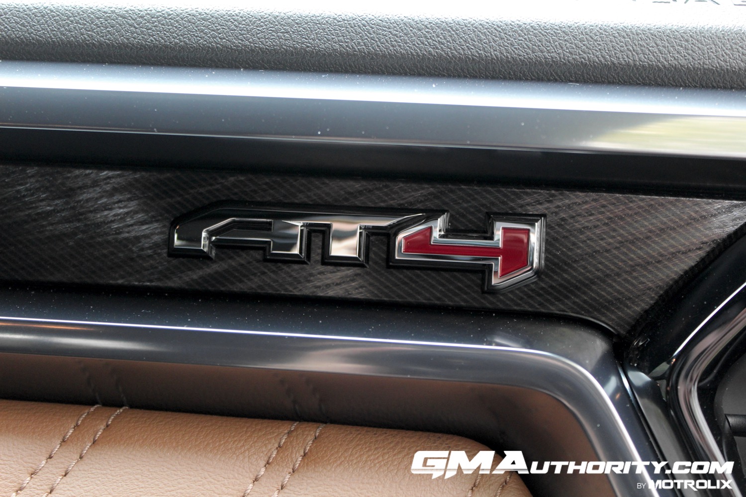2023-gmc-canyon-at4-jet-black-with-timber-hx6-first-drive-interior-023-at4-logo-badge-on-dash