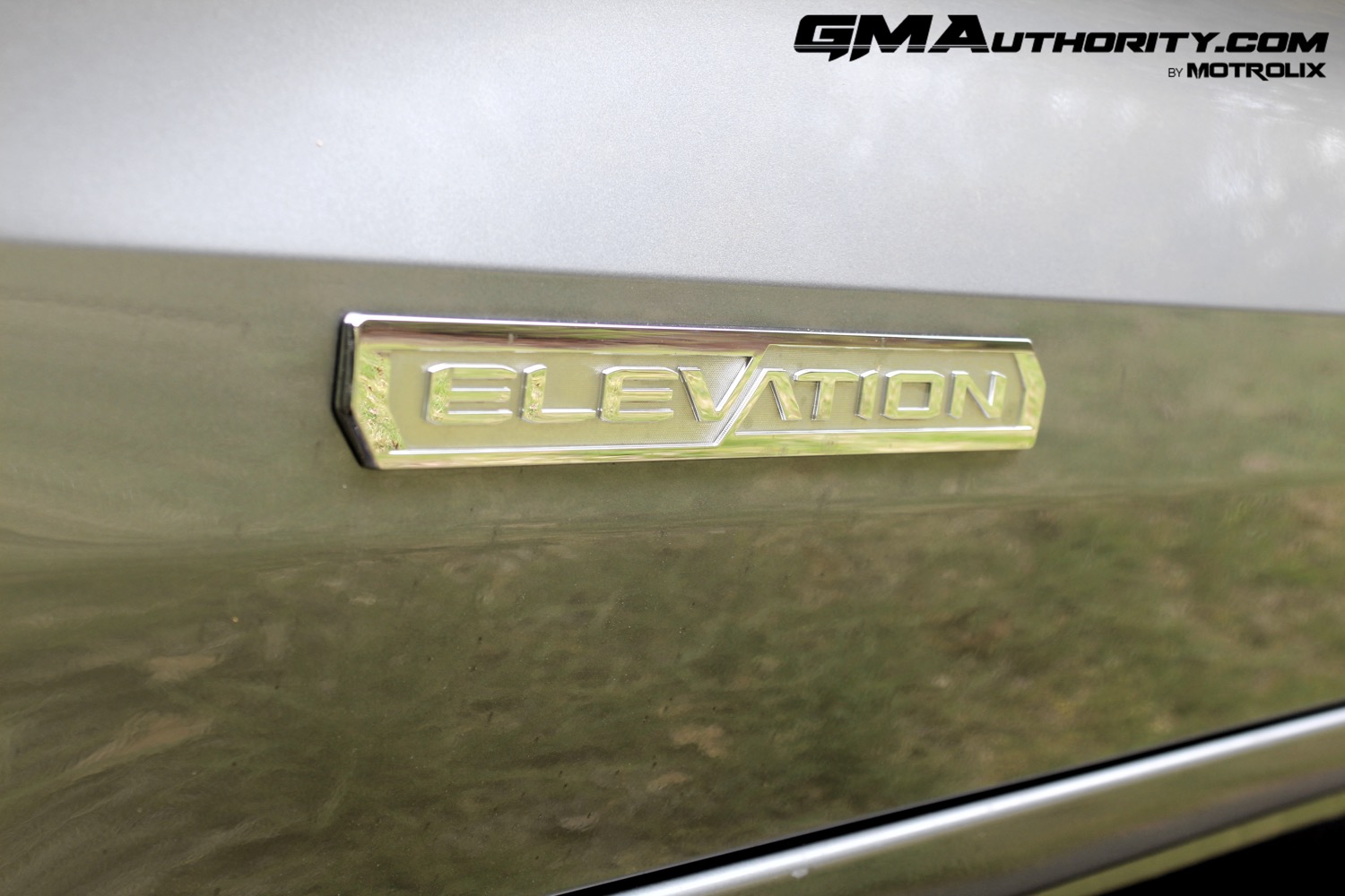 2023-gmc-canyon-elevation-sterling-metallic-gxd-first-drive-exterior-048-elevation-logo-badge-on-door