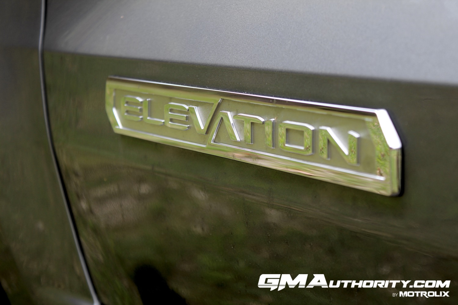 2023-gmc-canyon-elevation-sterling-metallic-gxd-first-drive-exterior-051-elevation-logo-badge-on-door