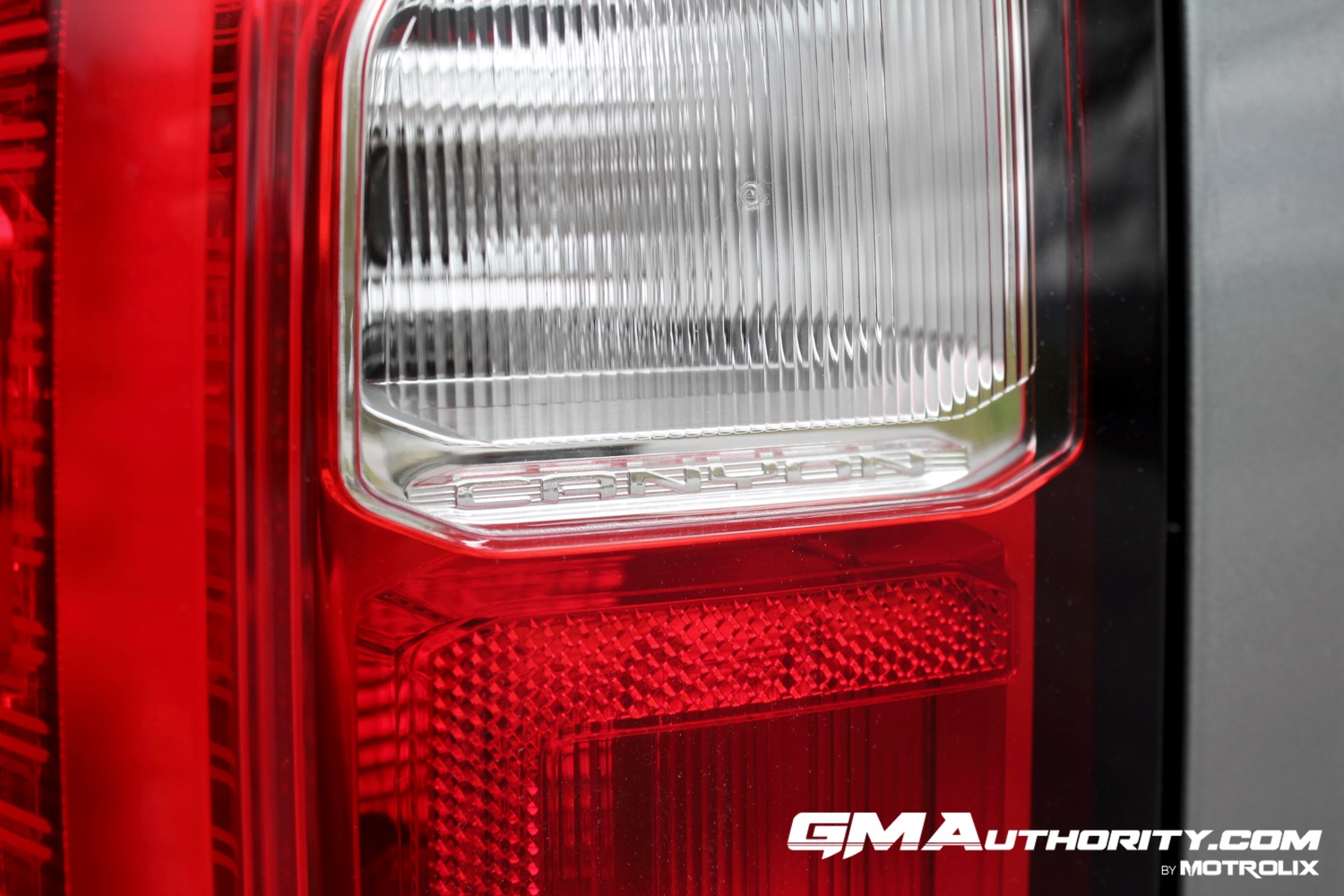 2023-gmc-canyon-elevation-sterling-metallic-gxd-first-drive-exterior-067-canyon-script-in-tail-light-detail