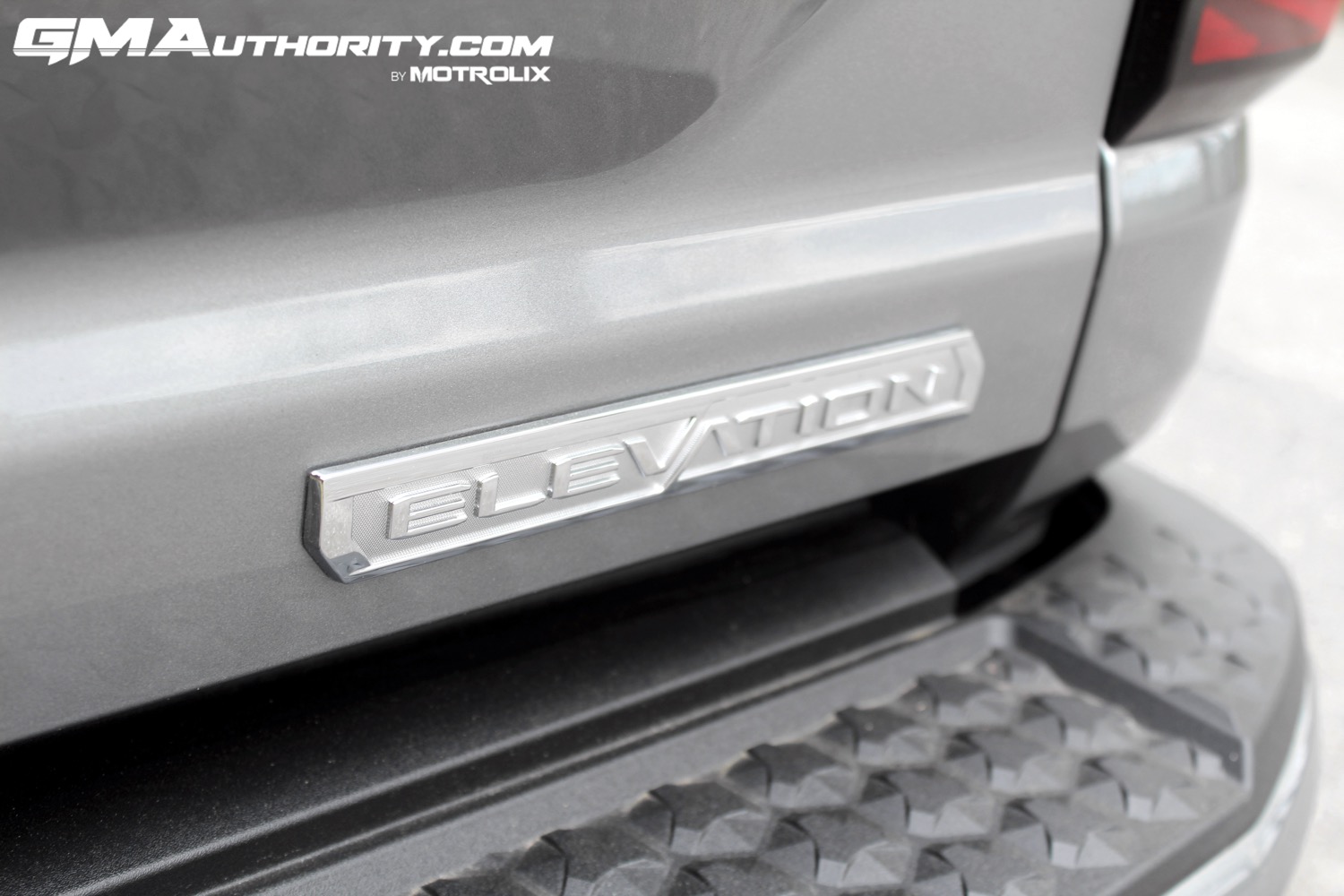 2023-gmc-canyon-elevation-sterling-metallic-gxd-first-drive-exterior-077-elevation-logo-badge-on-tailgate