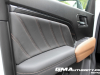 2023-gmc-canyon-at4-jet-black-with-timber-hx6-first-drive-interior-003-driver-door-panel-detail-door-pull-handle-knee-rest-pad