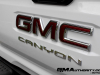 2023-gmc-canyon-at4-summit-white-gaz-first-drive-exterior-069-gmc-canyon-logo-badge-on-tailgate
